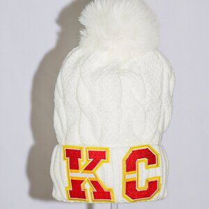White stocking cap with K.C. letters in Chiefs colors with fuzzy lining